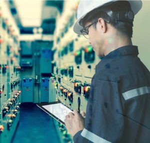 Engineer working with tablet in electrical room