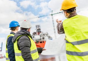 Men wearing safety helmets and yellow vests